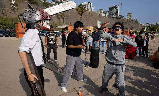 Young men dressed as “Mr. Chainsaw” and “Maduro” face off in an aura-farming battle at Las Sombrillas beach in Lima, Peru, on Aug. 29, 2026. (AP Photo/Martin Mejia)