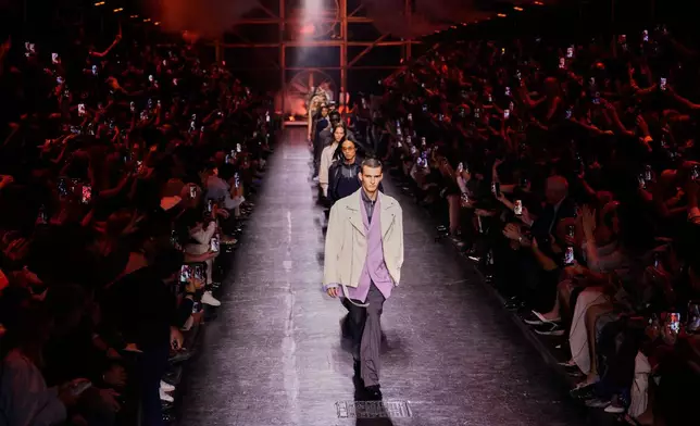 Models wear creations from Diesel's Spring-Summer 2027 collection presented in Milan, Italy, Tuesday, Sept. 22, 2026. (AP Photo/Luca Bruno)