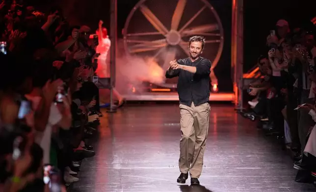 Designer Glenn Martens accepts applause after his Diesel women's Spring-Summer 2027 collection presented in Milan, Italy, Tuesday, Sept. 22, 2026. (AP Photo/Luca Bruno).