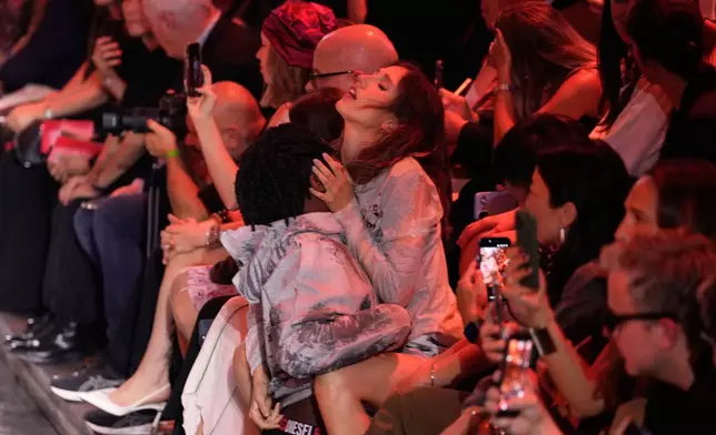 A couple perform during the Diesel women's Spring-Summer 2027 collection fashion show in Milan, Italy, Tuesday, Sept. 22, 2026. (AP Photo/Luca Bruno).