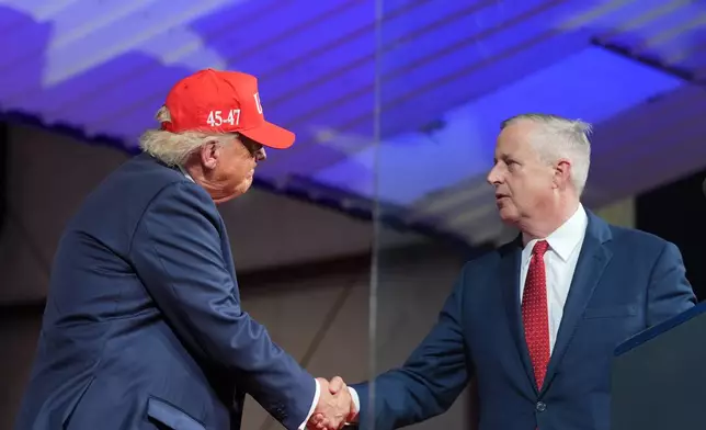 President Donald Trump greets North Carolina Republican U.S. Senate candidate Michael Whatley during a rally at Gastonia Municipal Airport, Wednesday, Sept. 16, 2026, in Gastonia, N.C. (AP Photo/Alex Brandon)