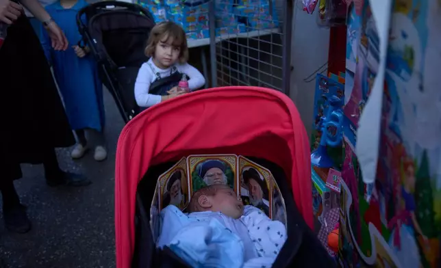 A Jewish baby sleeps in a stroller decorated with pictures of rabbis, in Jerusalem's Mea Shearim neighborhood, Wednesday, Sept. 23, 2026. (AP Photo/Ohad Zwigenberg)