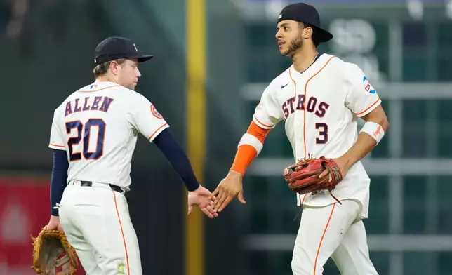 Houston Astros' Jeremy Peña (3) and Nick Allen (20) celebrate after a baseball game against the Kansas City Royals Thursday, Sept. 17, 2026, in Houston. (AP Photo/David J. Phillip)