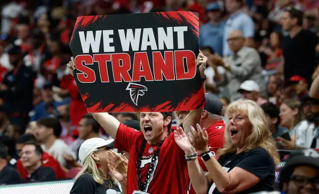 Atlanta Falcons fans hold up a sign "We Want Strand" for Atlanta Falcons quarterback Jack Strand (18) during an NFL football game in Atlanta, Sunday, Sept. 20, 2026. (AP Photo/Erik S. Lesser)