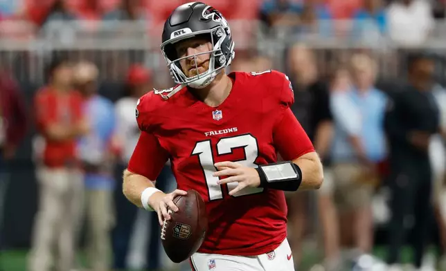 Atlanta Falcons quarterback Cooper Rush (13) warms up before an NFL football game against the Carolina Panthers in Atlanta, Sunday, Sept. 20, 2026. (AP Photo/Erik Lesser)