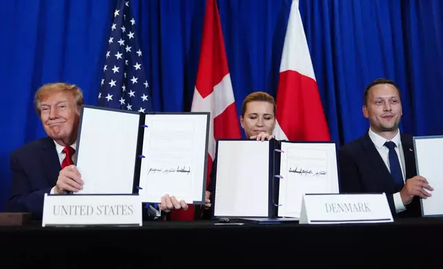 President Donald Trump signs a security agreement with Denmark's Prime Minister Mette Frederiksen and Greenland's Prime Minister Jens-Frederik Nielsen during the United Nations General Assembly, Tuesday, Sept. 22, 2026, at the UN headquarters. (AP Photo/Julia Demaree Nikhinson)