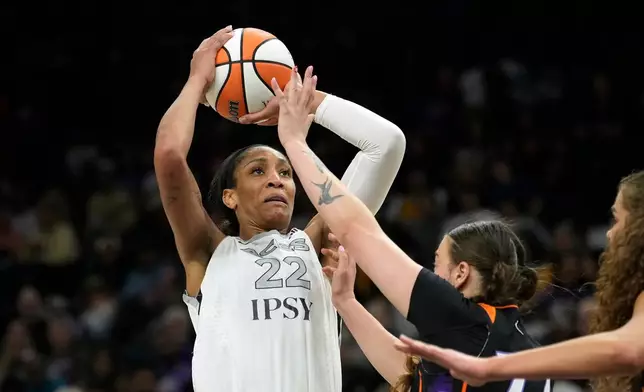 Las Vegas Aces center A'ja Wilson (22) shoots over Phoenix Mercury forward Marta Suarez and Mercury forward Maddy Westbeld, right, during the second half of a WNBA basketball game, Thursday, Sept. 24, 2026, in Phoenix. (AP Photo/Ross D. Franklin)