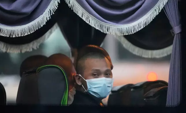 Myanmar nationals look out from a bus in Manjung, Perak state of Malaysia, on Tuesday, Sept. 29, 2026. (AP Photo/Vincent Thian)