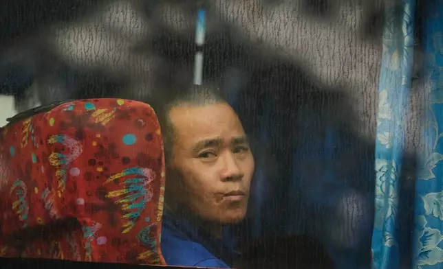 One of Myanmar nationals looks out from a bus in Manjung, Perak state of Malaysia, on Tuesday, Sept. 29, 2026. (AP Photo/Vincent Thian)