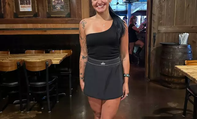 Madison McDonald stops to discuss the "no tax on tips" deduction in between serving tables at the Silver Star Smokehouse & Tavern, Tuesday, Aug. 25 in Bossier City, La. (AP Photo/Lisa Mascaro)