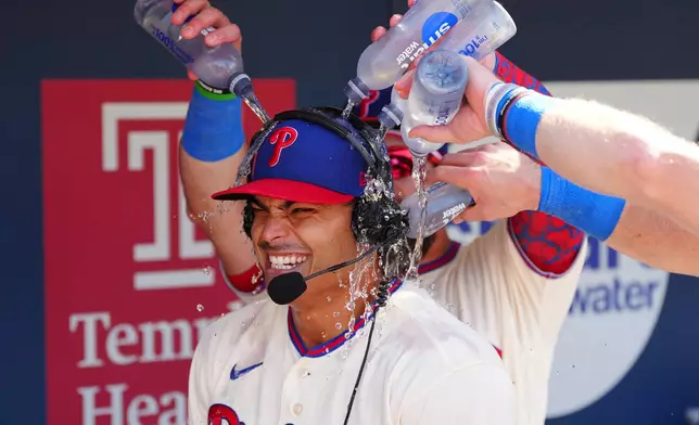 Philadelphia Phillies pitcher Jesús Luzardo is doused by teammates in the dugout after a baseball game against the Atlanta Braves, Monday, Sept. 7, 2026, in Philadelphia. (AP Photo/Derik Hamilton)