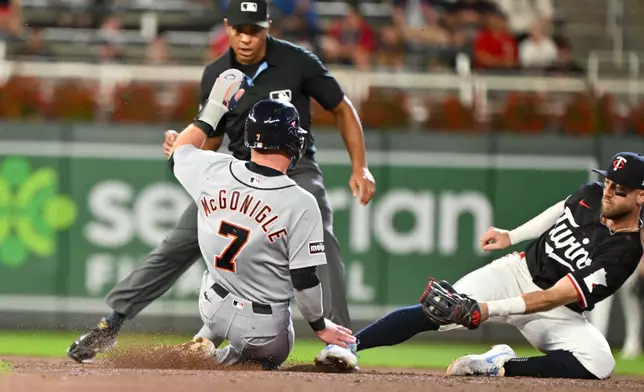 Minnesota Twins second baseman Kody Clemens, right, misses the tag as Detroit Tigers' Kevin McGonigle (7) steals second base during the fifth inning of a baseball game Wednesday, Sept. 2, 2026, in Minneapolis. (AP Photo/Craig Lassig)