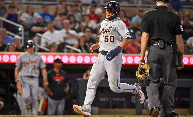 Detroit Tigers' Hao-Yu Lee scores on a RBI double by Riley Greene against the Minnesota Twins during the fifth inning of a baseball game Wednesday, Sept. 2, 2026, in Minneapolis. (AP Photo/Craig Lassig)