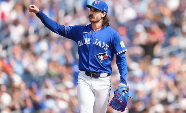 Toronto Blue Jays pitcher Dylan Cease reacts to the crowd and teammates after getting out of a jam with the bases loaded during the first inning of a baseball game against the Baltimore Orioles in Toronto, Sunday, Sept. 13, 2026. (Nathan Denette/The Canadian Press via AP)
