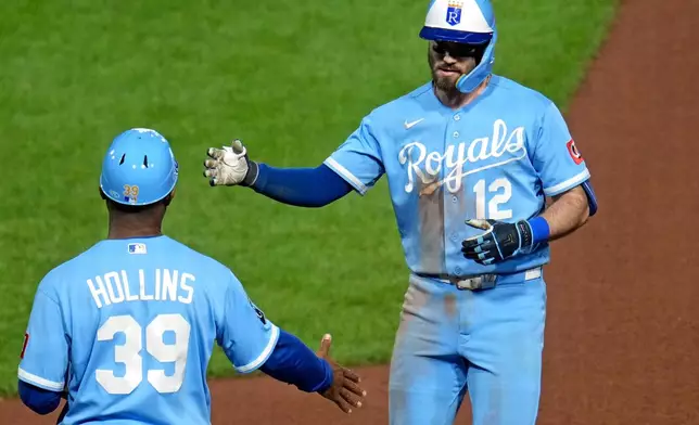 Kansas City Royals' Nick Loftin (12) celebrates with first base coach Damon Hollins (39) after driving in a run with a single off Pittsburgh Pirates pitcher Camilo Doval during the seventh inning of a baseball game in Pittsburgh, Saturday, Sept. 19, 2026. (AP Photo/Gene J. Puskar)