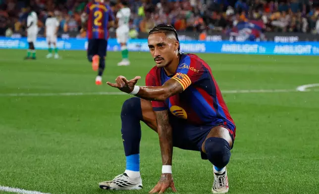 Barcelona's Raphinha celebrates after scoring his side's second goal from the penalty spot during a Spanish La Liga soccer match between Barcelona and Racing de Santander in Barcelona, Spain, Wednesday, Sept. 16, 2026. (AP Photo/Joan Monfort)