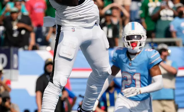 Philadelphia Eagles wide receiver Darius Cooper (80) catches a touchdown pass over Tennessee Titans cornerback Micah Robinson (21) during the second half of an NFL football game, Sunday, Sept. 20, 2026, in Nashville, Tenn.(AP Photo/George Walker IV)