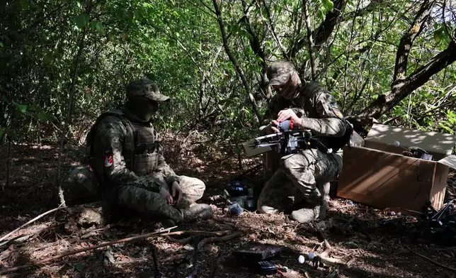 In this photo provided by Ukraine's 65th Mechanized Brigade press service, Ukrainian soldiers prepare an FPV drone to fire towards Russian positions in Zaporizhzhia region, Ukraine, Saturday, Sept. 19, 2026. (Andriy Andriyenko/Ukraine's 65th Mechanized Brigade via AP)