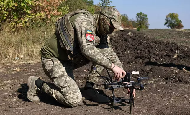 In this photo provided by Ukraine's 65th Mechanized Brigade press service, a Ukrainian soldier prepares an FPV drone to fire towards Russian positions in Zaporizhzhia region, Ukraine, Saturday, Sept. 19, 2026. (Andriy Andriyenko/Ukraine's 65th Mechanized Brigade via AP)