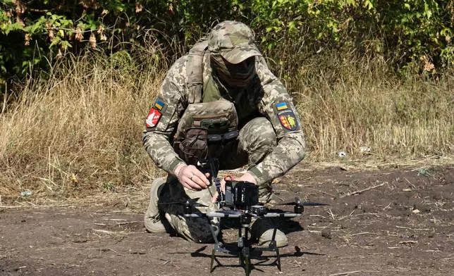 In this photo provided by Ukraine's 65th Mechanized Brigade press service, a Ukrainian soldier prepares an FPV drone to fire towards Russian positions in Zaporizhzhia region, Ukraine, Saturday, Sept. 19, 2026. (Andriy Andriyenko/Ukraine's 65th Mechanized Brigade via AP)