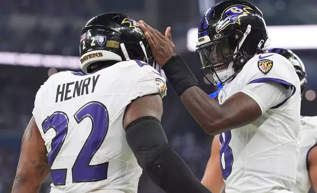 Baltimore Ravens' Lamar Jackson congratulates Derrick Henry on his touchdown run during the first half of an NFL football game against the Indianapolis Colts Sunday, Sept. 13, 2026, in Indianapolis. (AP Photo/Jeff Roberson)
