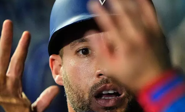 Toronto Blue Jays' George Springer celebrates in the dugout after scoring on a single by Kazuma Okamoto during the seventh inning of a baseball game against the Kansas City Royals, Saturday, Sept. 5, 2026, in Kansas City, Mo. (AP Photo/Charlie Riedel)