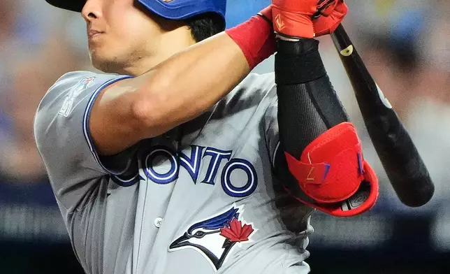 Toronto Blue Jays' Kazuma Okamoto watches his RBI single during the seventh inning of a baseball game against the Kansas City Royals, Saturday, Sept. 5, 2026, in Kansas City, Mo. (AP Photo/Charlie Riedel)