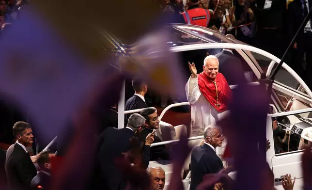 Pope Leo XIV arrives on the popemobile at the Stade de France in Saint-Denis near Paris to preside over Vespers with young people, Friday, Sept. 25, 2026. (AP Photo/Thomas Padilla)
