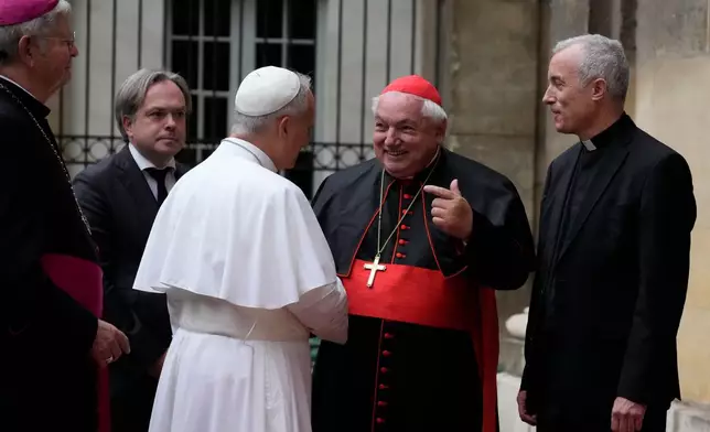 Pope Leo XIV is welcomed by Archbishop of Paris Laurent Ulrich, left, Cardinal Jean-Marc Aveline, second from right, and Institut Catholique de Paris Rector Emmanuel Petit as he arrives to meet with members of the provincial synodal assembly, catechumens and neophytes at the ICP in Paris, Saturday, Sept. 26, 2026. (AP Photo/Gregorio Borgia)