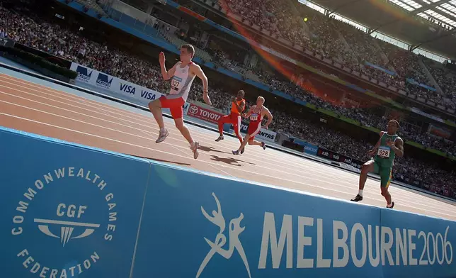 FILE - Competitors run in a heat of the Men's 100m elite disabled athlete race T12 at the Melbourne Cricket Ground at the Commonwealth Games in Melbourne, Australia, March 19, 2006. (AP Photo/Alastair Grant, File)