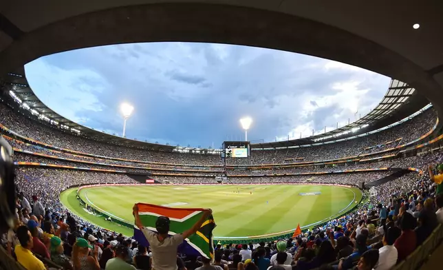 FILE - A South Africa fan holds up the national flag during their Cricket World Cup pool B match against India at the Melbourne Cricket Ground in Melbourne, Australia, Feb. 22, 2015. (AP Photo/Theo Karanikos, File)