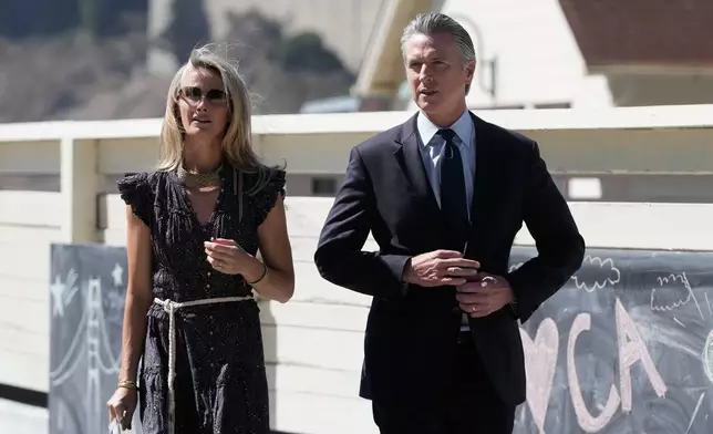 California Gov. Gavin Newsom, right, and his wife, First partner Jennifer Siebel Newsom, arrive at the Bay Area Discovery Museum, Thursday, Sept. 10, 2026, in Sausalito, Calif. (AP Photo/Jeff Chiu)