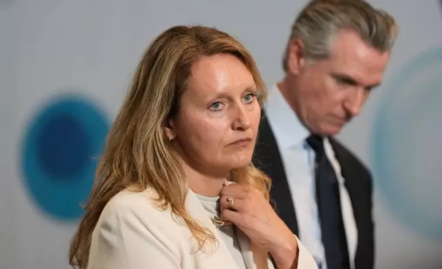 Assemblymember Buffy Wicks, left, listens to speakers next to California Gov. Gavin Newsom during a news conference at the Bay Area Discovery Museum, Thursday, Sept. 10, 2026, in Sausalito, Calif. (AP Photo/Jeff Chiu)