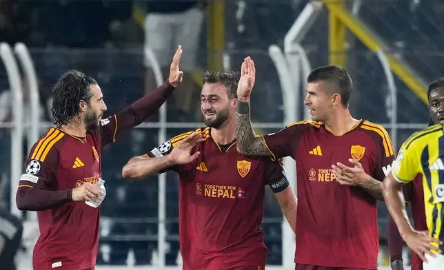 Roma's Bryan Cristante, centre, celebrates after scoring his side's first goal during the Champions League opening phase soccer match between Fenerbahce and Roma in Istanbul, Turkey, Thursday, Sept. 10, 2026. (AP Photo/Khalil Hamra)