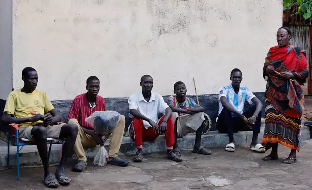 Young men and boys who fled drought in South Sudan sit alongside a chief in Torit, the capital of Eastern Equatoria state, South Sudan, Friday, Aug. 14, 2026. (AP Photo/Juma Peter)