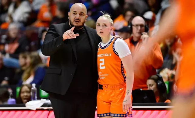 Connecticut Sun head coach Rachid Meziane talks with Connecticut Sun guard Hailey Van Lith in the first half of a WNBA basketball game against the Toronto Tempo, Thursday, Sept. 24, 2026, in Uncasville, Conn. (AP Photo/Jessica Hill)