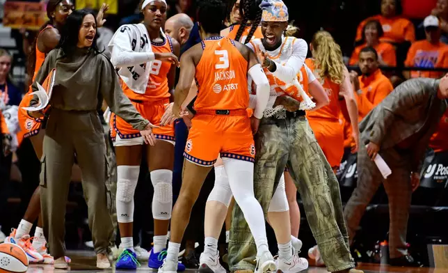 Connecticut Sun's Saniya Rivers, right, greets Connecticut Sun guard Ashlon Jackson at a time out in the first half of a WNBA basketball game against the Toronto Tempo, Thursday, Sept. 24, 2026, in Uncasville, Conn. (AP Photo/Jessica Hill)