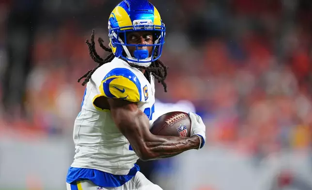 Los Angeles Rams wide receiver Davante Adams catches a pass against the Denver Broncos during the first half of an NFL football game Sunday, Sept. 27, 2026, in Denver. (AP Photo/Jack Dempsey)