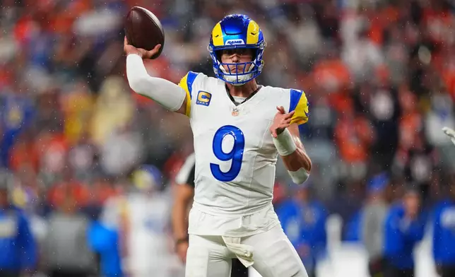 Los Angeles Rams quarterback Matthew Stafford throws a touchdown pass against the Denver Broncos during the first half of an NFL football game Sunday, Sept. 27, 2026, in Denver. (AP Photo/Jack Dempsey)