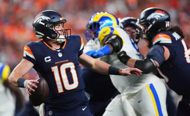 Denver Broncos quarterback Bo Nix looks to pass against the Los Angeles Rams during the first half of an NFL football game Sunday, Sept. 27, 2026, in Denver. (AP Photo/David Zalubowski)