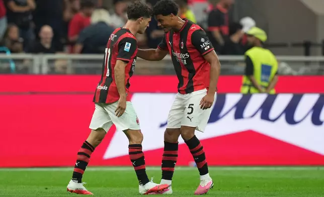 AC Milan's Christian Pulisic, left, celebrates after scoring his side's opening goal during the Serie A soccer match between AC Milan and Lecce, in Milan, Italy, Sunday, Sept. 20, 2026. (AP Photo/Antonio Calanni)