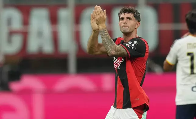 AC Milan's Christian Pulisic greets supporters as he is substituted during the Serie A soccer match between AC Milan and Lecce, in Milan, Italy, Sunday, Sept. 20, 2026. (AP Photo/Antonio Calanni)