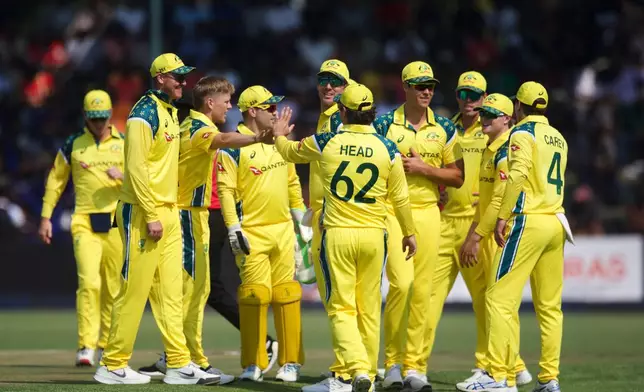Australia players celebrate a wicket during the first One Day International cricket match between Zimbabwe and Australia in Harare, Zimbabwe, Tuesday, Sept.15, 2026. (AP Photo/Wonder Mashura)