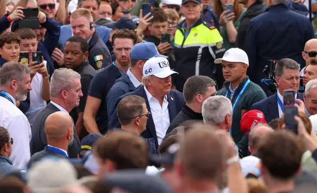 U.S. President Donald Trump makes his way through spectators as he attends the Irish Open at the Trump International Golf Links course in Doonbeg, Ireland, Sunday, Sept. 13, 2026.(AP Photo/Peter Morrison)