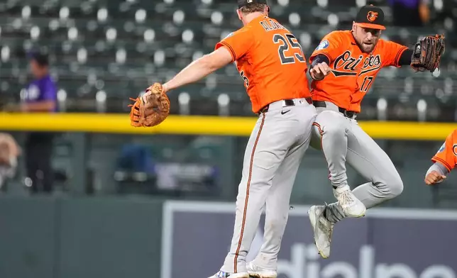 Baltimore Orioles first baseman Pete Alonso, left, celebrates with center fielder Colton Cowser after defeating the Colorado Rockies in a baseball game Monday, Aug. 31, 2026, in Denver. (AP Photo/David Zalubowski)
