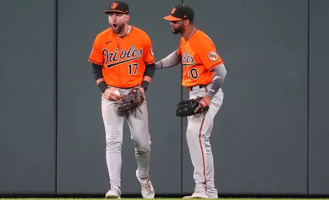 Baltimore Orioles center fielder Colton Cowser, left, yells as right fielder Leody Taveras looks on after Cowser robbed Colorado Rockies' Jake McCarthy of a two-run, walkoff home run to end the ninth inning of a baseball game Monday, Aug. 31, 2026, in Denver. (AP Photo/David Zalubowski)