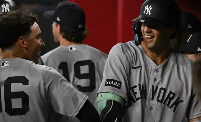 New York Yankees' George Lombard Jr., left, celebrates with Spencer Jones, right, after they hit home runs during the third inning of a baseball game against the Arizona Diamondbacks, Sunday, Sept. 20, 2026, in Phoenix. (AP Photo/Caitlin O'Hara)