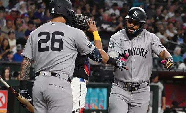 New York Yankees' Heliot Ramos, right, celebrates with Luis García Jr. (26) after Ramos' home run during the third inning of a baseball game against the Arizona Diamondbacks, Sunday, Sept. 20, 2026, in Phoenix. (AP Photo/Caitlin O'Hara)