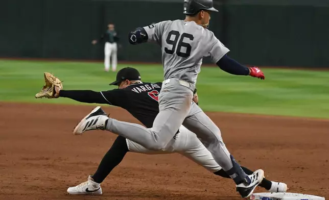 Arizona Diamondbacks' Ildemaro Vargas, left, catches out New York Yankees' George Lombard Jr. (96) during the eighth inning of a baseball game, Sunday, Sept. 20, 2026, in Phoenix. (AP Photo/Caitlin O'Hara)wld