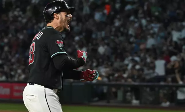 Arizona Diamondbacks' Nolan Arenado celebrates after hitting a grand slam in the fifth inning of a baseball game against the New York Yankees, Sunday, Sept. 20, 2026, in Phoenix. (AP Photo/Caitlin O'Hara)